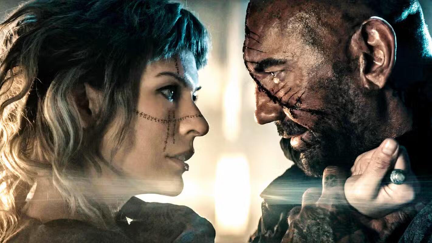 milla jovovich grabs dave bautista in image for in the lost lands فیلم in the lost lands